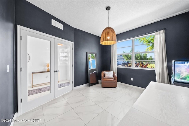 14119 SW Safi Ter, Port St Lucie, FL 34987 - sitting room featuring a textured ceiling, visible vents, marble finish floor, french doors, and baseboards