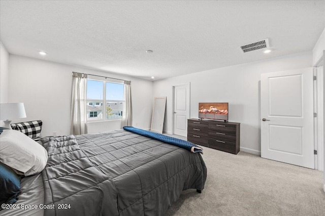 carpeted bedroom featuring a textured ceiling