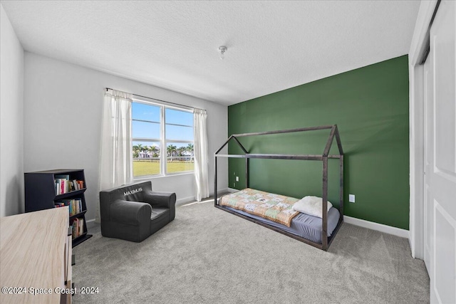 14119 SW Safi Ter, Port St Lucie, FL 34987 - carpeted bedroom featuring a textured ceiling and baseboards