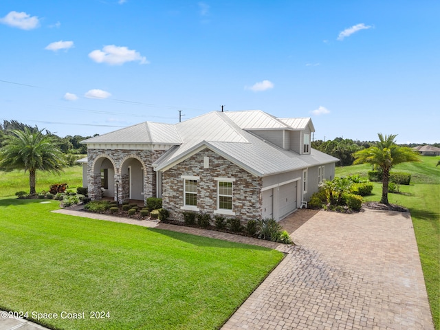 view of front of property featuring a garage and a front lawn