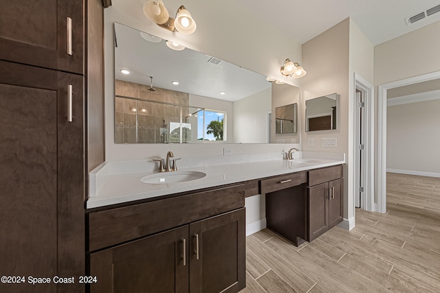 bathroom featuring walk in shower, vanity, and hardwood / wood-style floors