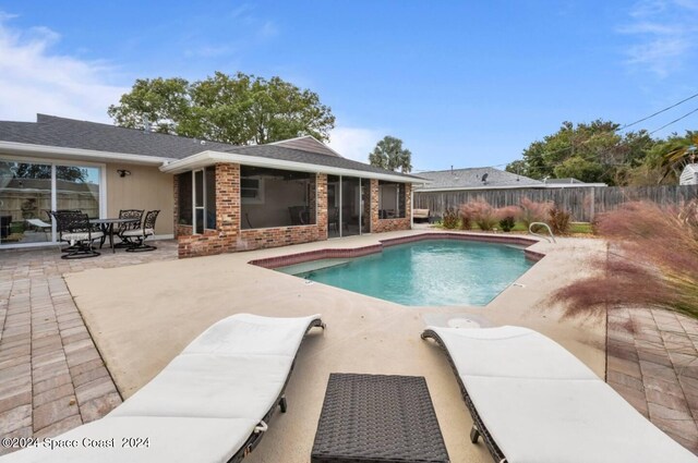 902 Beaverdale Ln, Rockledge, FL 32955 - view of pool featuring a sunroom, a fenced backyard, a fenced in pool, and a patio area