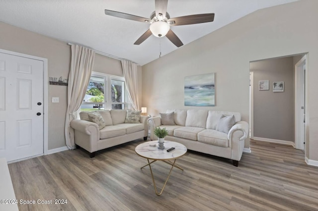 902 Beaverdale Ln, Rockledge, FL 32955 - living area featuring a ceiling fan, baseboards, lofted ceiling, and light wood-style floors