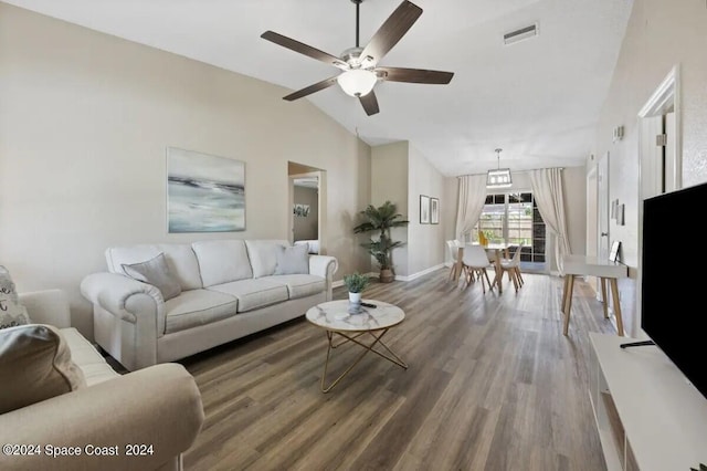 902 Beaverdale Ln, Rockledge, FL 32955 - living area featuring visible vents, baseboards, vaulted ceiling, wood finished floors, and a ceiling fan
