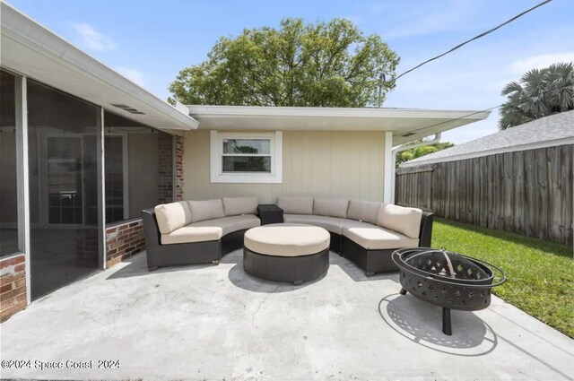 902 Beaverdale Ln, Rockledge, FL 32955 - view of patio / terrace with fence and an outdoor living space with a fire pit