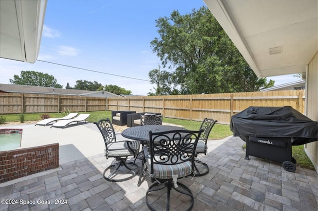 902 Beaverdale Ln, Rockledge, FL 32955 - view of patio with outdoor dining space, a grill, and a fenced backyard