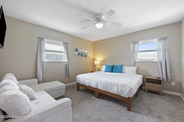 902 Beaverdale Ln, Rockledge, FL 32955 - bedroom with a textured ceiling, ceiling fan, carpet, and baseboards