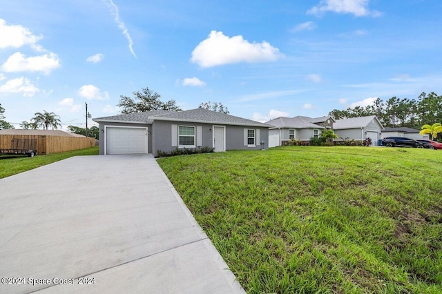 ranch-style house featuring a garage and a front yard