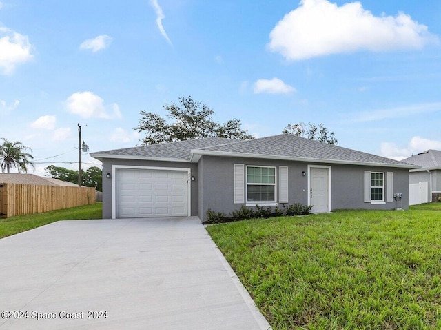 single story home with a garage and a front lawn