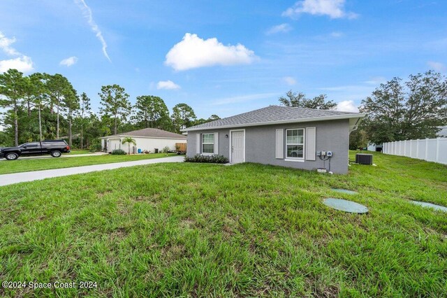 single story home with central AC and a front lawn