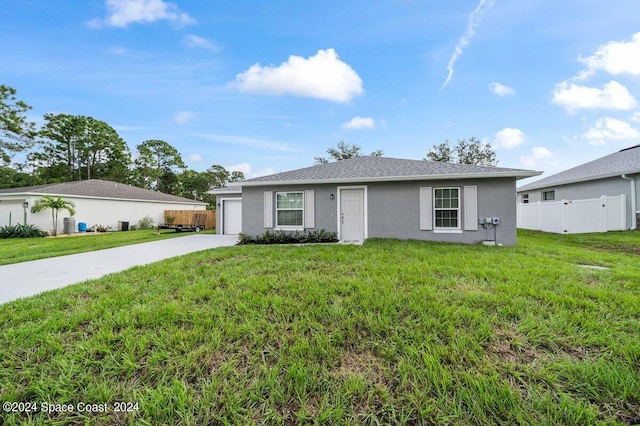 ranch-style home featuring a front lawn and a garage