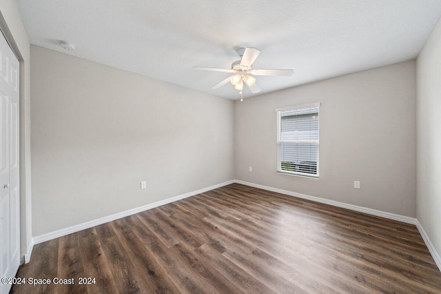 unfurnished room featuring a textured ceiling, ceiling fan, and dark hardwood / wood-style floors