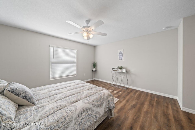 bedroom with a textured ceiling, dark hardwood / wood-style flooring, and ceiling fan