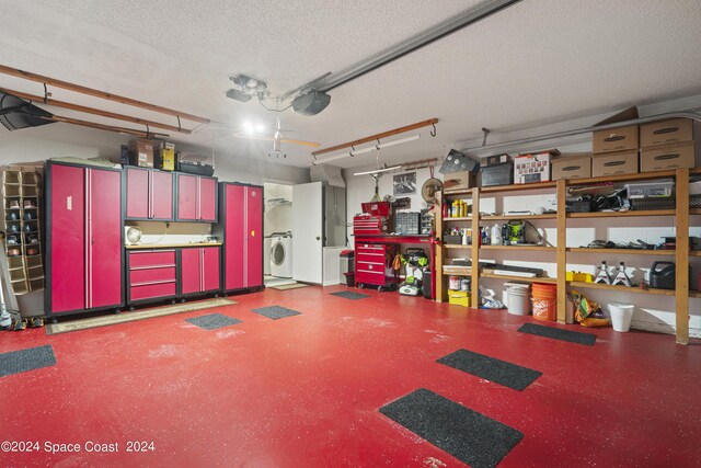 garage featuring washer / clothes dryer and a garage door opener