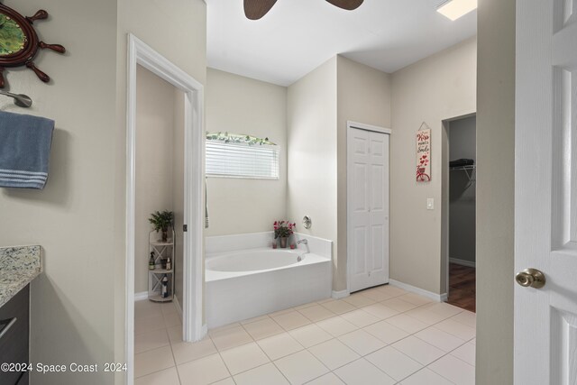 bathroom with tile patterned flooring, vanity, a bathtub, and ceiling fan