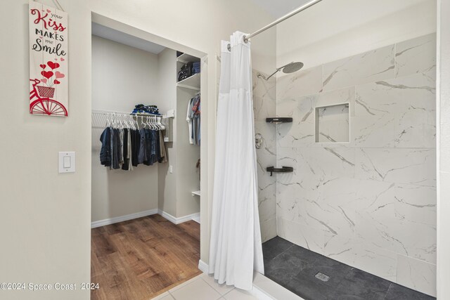 bathroom featuring wood-type flooring and walk in shower