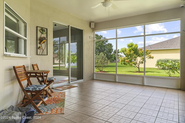 sunroom featuring ceiling fan