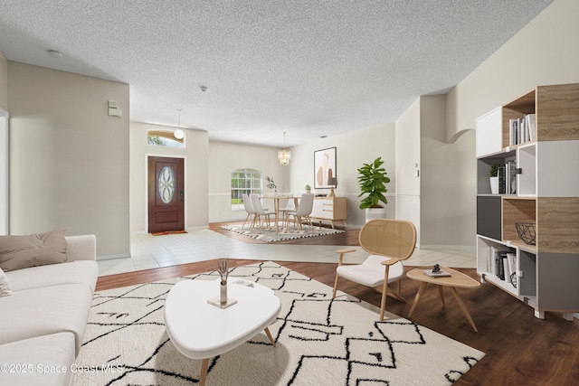 living room featuring light hardwood / wood-style flooring and a textured ceiling