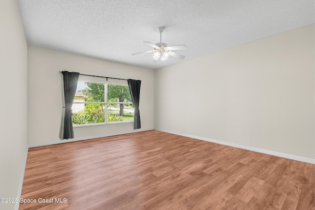 spare room with ceiling fan, a textured ceiling, and light hardwood / wood-style flooring