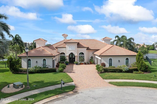 mediterranean / spanish-style house featuring a front yard