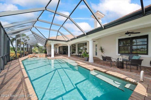 view of swimming pool featuring a lanai, a patio, and ceiling fan