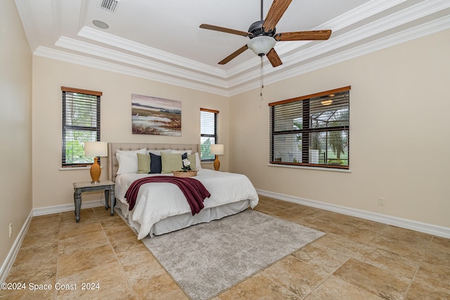 bedroom with crown molding, a tray ceiling, and ceiling fan