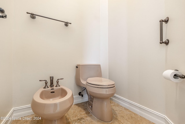 bathroom featuring a bidet and toilet