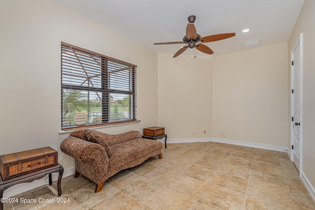 sitting room featuring ceiling fan