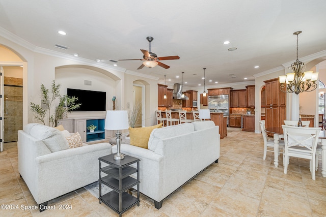 living room featuring ceiling fan with notable chandelier and crown molding