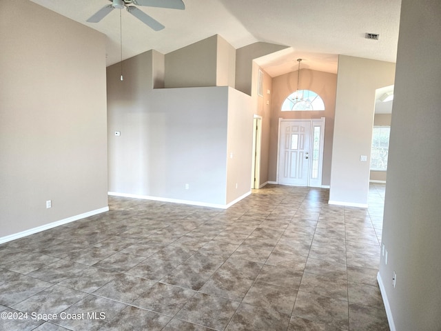 entrance foyer featuring a textured ceiling, tile patterned flooring, high vaulted ceiling, and ceiling fan