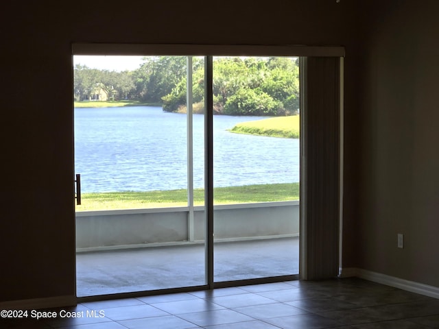 entryway with tile patterned floors and a water view