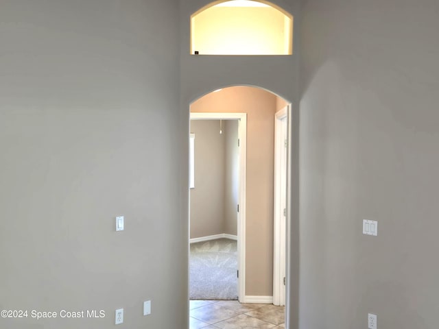 hallway featuring light tile patterned floors