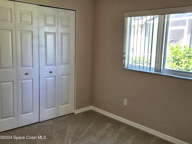 unfurnished bedroom featuring a closet and carpet