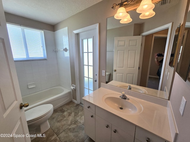 full bathroom with vanity, toilet, a textured ceiling, and plenty of natural light