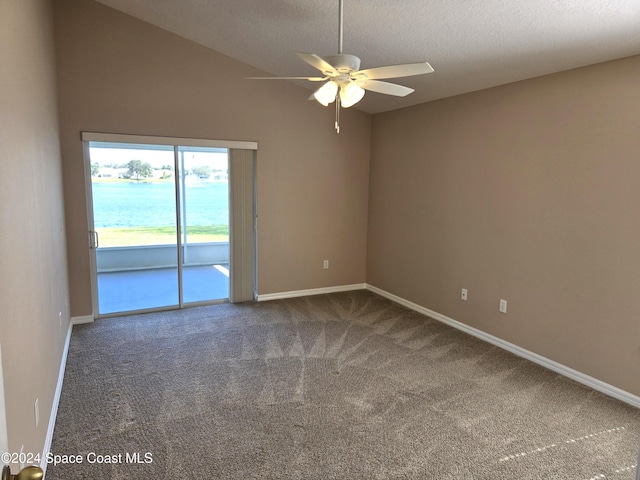 carpeted spare room with a water view, ceiling fan, a textured ceiling, and lofted ceiling