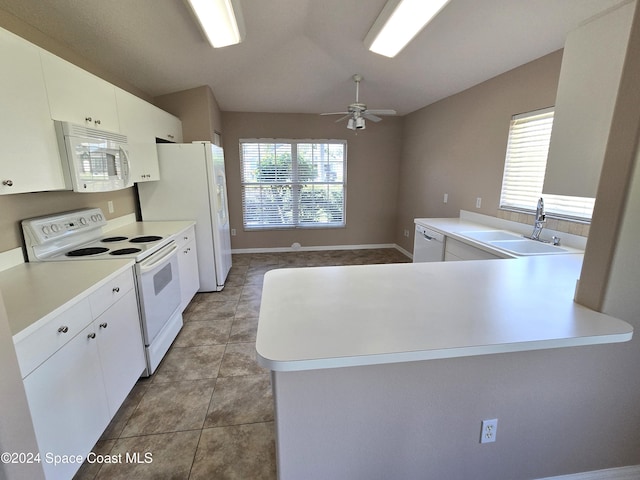 kitchen featuring kitchen peninsula, a wealth of natural light, and white appliances