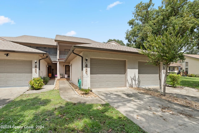 view of front facade with a front yard and a garage