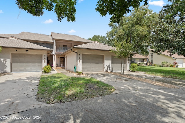 view of front facade with a garage and a front lawn