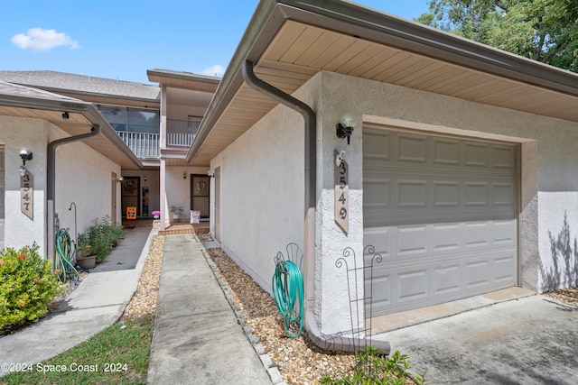 view of side of property with a balcony and a garage