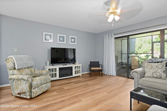 living room with ceiling fan and light hardwood / wood-style floors