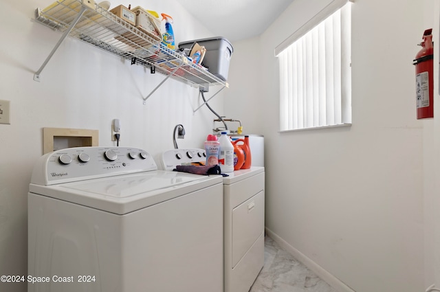 clothes washing area with separate washer and dryer