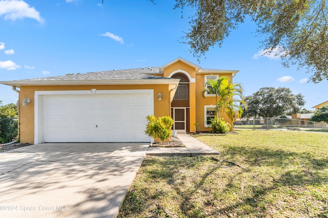 view of front of home with a front lawn and a garage