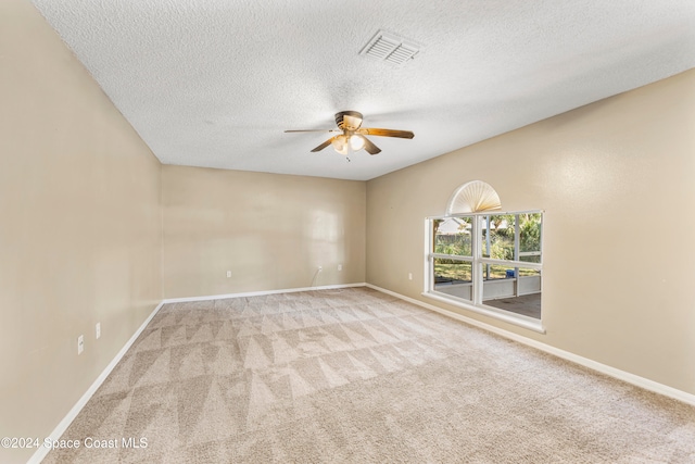 unfurnished room with a textured ceiling, light colored carpet, and ceiling fan