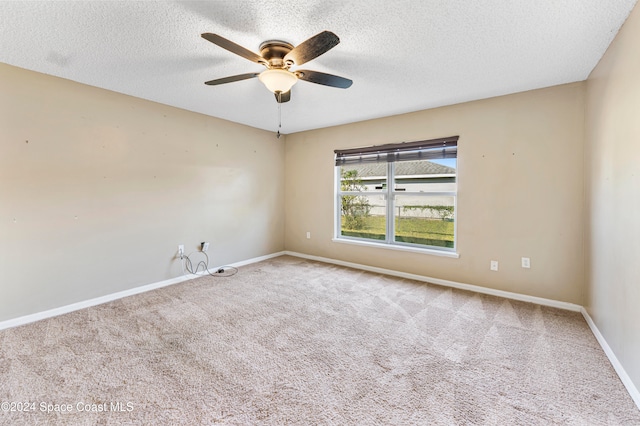 spare room featuring a textured ceiling, carpet flooring, and ceiling fan