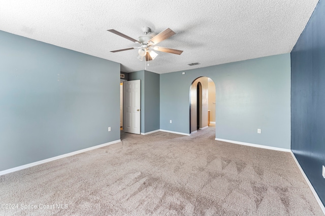 unfurnished room featuring ceiling fan, light carpet, and a textured ceiling