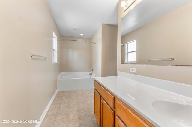 bathroom with vanity and a tub