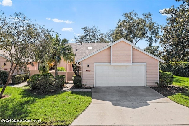 ranch-style home with a front lawn and a garage