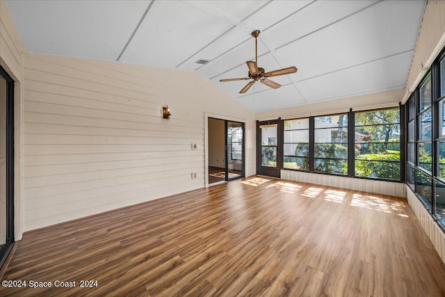 unfurnished sunroom with ceiling fan and vaulted ceiling