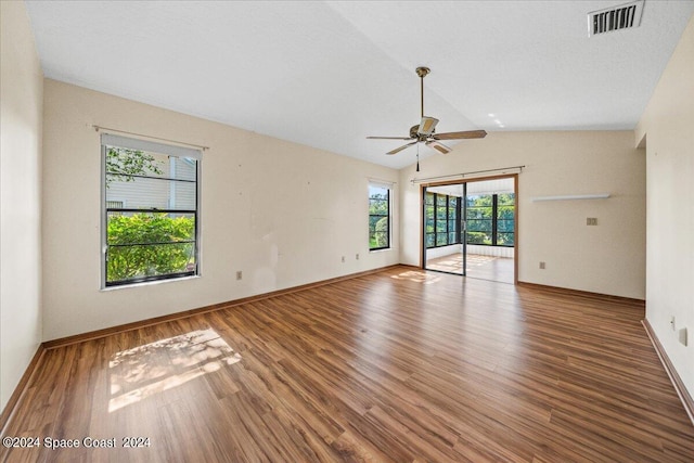 spare room with ceiling fan, hardwood / wood-style floors, vaulted ceiling, and a healthy amount of sunlight