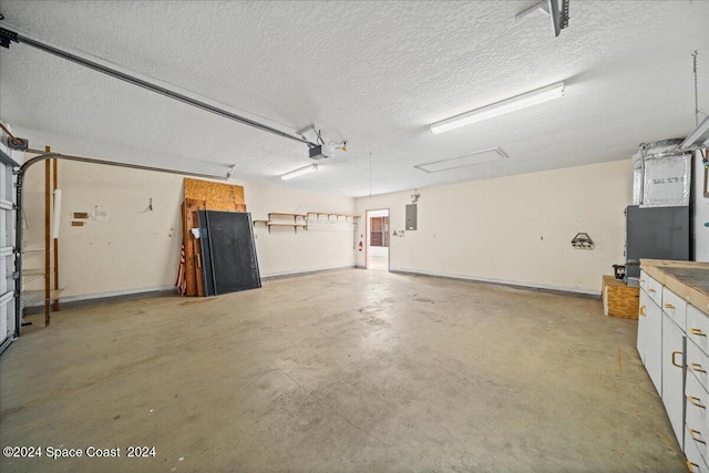 garage featuring a garage door opener, heating unit, and electric panel